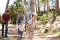 Family Running Along Path Through Forest Together Royalty Free Stock Photo
