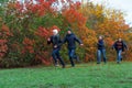 Family running in autumn city park, happy people together, parents and children, beautiful nature with colorful leaves Royalty Free Stock Photo