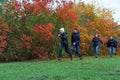 Family running in autumn city park, happy people together, parents and children, beautiful nature with colorful leaves Royalty Free Stock Photo