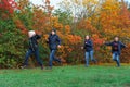 Family running in autumn city park, happy people together, parents and children, beautiful nature with colorful leaves Royalty Free Stock Photo