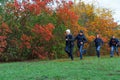 Family running in autumn city park, happy people together, parents and children, beautiful nature with colorful leaves Royalty Free Stock Photo