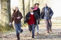 Family Running Through Autumn Countryside Royalty Free Stock Photo