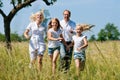 Family running in the meadow Royalty Free Stock Photo