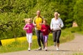 Family running in the meadow for sport Royalty Free Stock Photo