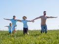 Family running with outstretched arms Royalty Free Stock Photo