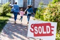 family running to new house with sold signboard Royalty Free Stock Photo