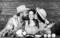 Family rustic style farmers at market with vegetables fruits and greenery. Parents and daughter harvest festival. Family