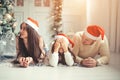 Family with Santa hat lying near Christmas tree, holiday celebration concept Royalty Free Stock Photo