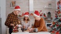 Family with santa hat speding christmas holiday together enjoying christmastime Royalty Free Stock Photo