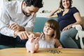 Family saving money in piggy bank Royalty Free Stock Photo