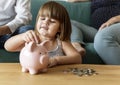 Family saving money in piggy bank Royalty Free Stock Photo