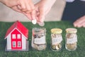 Family saving money putting coins into glass bank, Savings plans for housing, financial concept