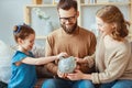 Family savings, budget planning, children`s pocket money. family with piggy Bank Royalty Free Stock Photo