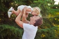 Family scene handsome young dad father posing playing with his baby daughter in central park forest summer meadow Happy life time