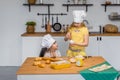 Two cute little sisters happily baking cookies and buns Royalty Free Stock Photo