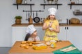 Two cute little sisters happily baking cookies and buns Royalty Free Stock Photo