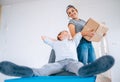 Family scene in new apartment - mother with son carry boxes Royalty Free Stock Photo