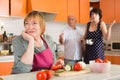 Family scolding woman in kitchen