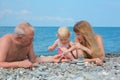 Family on sea coast and pyramid of s Royalty Free Stock Photo