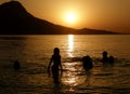 Family in sea at sunset Royalty Free Stock Photo