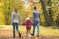 Happy family walking at autumn park