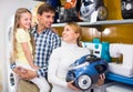 Family selecting vacuum cleaner