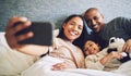 Family selfie, parents and child in a bed together with love, care and security or comfort. Woman, man and kid relax