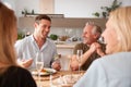 Family With Senior Parents And Adult Offspring Eating Brunch Around Table At Home Together Royalty Free Stock Photo