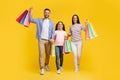 Family Shopping. Joyful Young Parents And Teen Daughter Holding Bright Shopper Bags Royalty Free Stock Photo