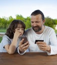 Family shopping online in the terrace on a summer evening Royalty Free Stock Photo