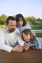 Family shopping online via the terrace on a summer evening Royalty Free Stock Photo