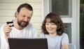 Family shopping online via the terrace on a summer evening Royalty Free Stock Photo