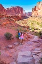 Smiling mother and daughter relaxing on hiking trip.