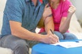 Family signs a document. Bank loan approvals Royalty Free Stock Photo