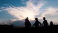 Family silhouette - father, mother and daughter and son walking holding hands Royalty Free Stock Photo