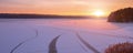 Family silhouette of four people figure skating at frozen lake against beautiful sunset. Royalty Free Stock Photo