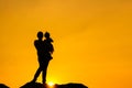 The family silhouette of the mother and child standing watch the sunset and the sky in orange in evening Royalty Free Stock Photo