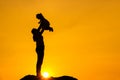 The family silhouette of the mother and child standing watch the sunset and the sky in orange in evening Royalty Free Stock Photo