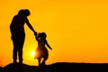 The family silhouette of the mother and child standing watch the sunset and the sky in orange in evening Royalty Free Stock Photo