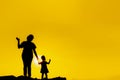 The family silhouette of the mother and child standing watch the sunset and the sky in orange in evening Royalty Free Stock Photo