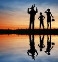 Family silhouette on sunset sky. Royalty Free Stock Photo