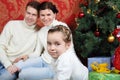 Family sit with gifts near Christmas tree at home Royalty Free Stock Photo