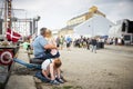 Family sitting away from crowd in Aalborg Tall Ship Race 2022 Royalty Free Stock Photo