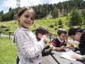 Family sitting on the bench in the mountains is happy