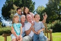 Family sitting on a bench taking photo of themselves Royalty Free Stock Photo