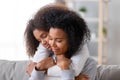 Loving mother and daughter with closed eyes embracing Royalty Free Stock Photo