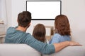 Family sitting on couch and watching Royalty Free Stock Photo