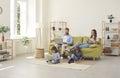 Parents and children sitting in the living room and using their modern digital devices Royalty Free Stock Photo