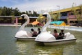 Family sitting on duck boats in an amusement water park in Kota Kinabalu, Malaysia