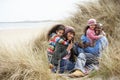 Family Sitting In Dunes Enjoying Picnic On Winter Royalty Free Stock Photo